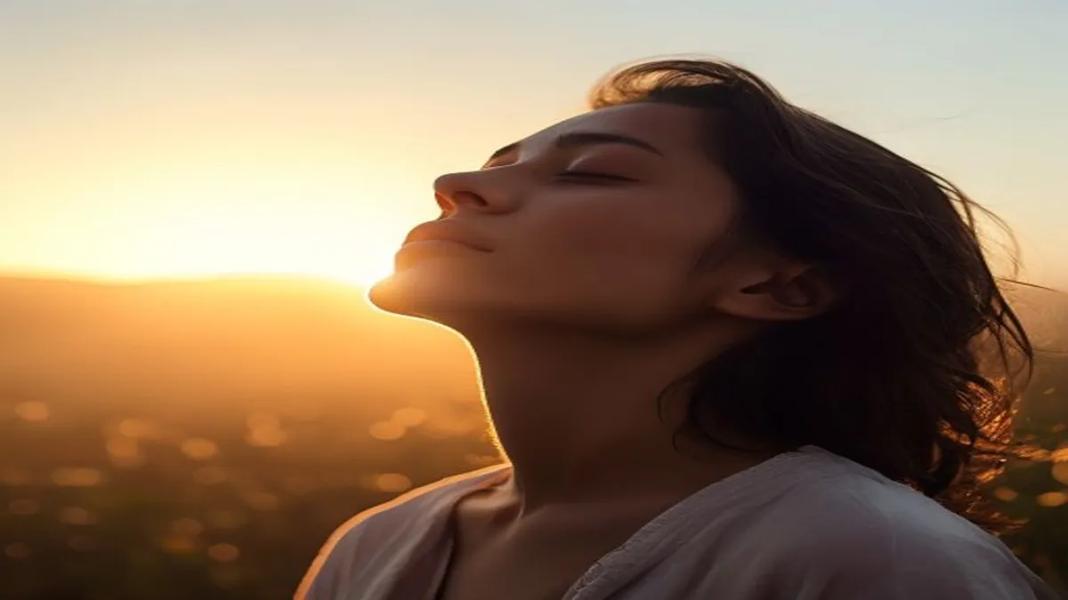 Person breathing deeply at sunrise overlook.