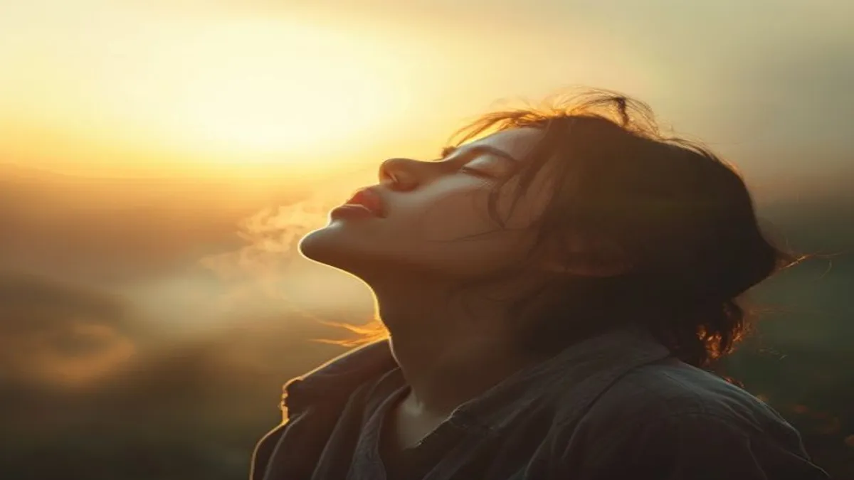 Person breathing deeply at sunrise overlook.